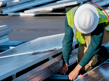 Worker installing solar panel