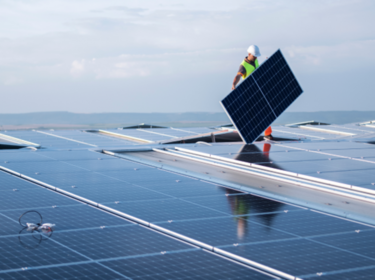 Worker installing solar panel